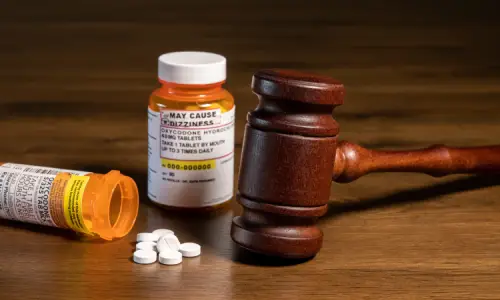 Bottles of medication on a table next to a gavel and soundblock.